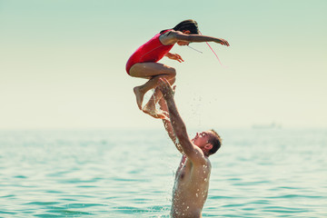Little girl kid and man father in sea water. Fun