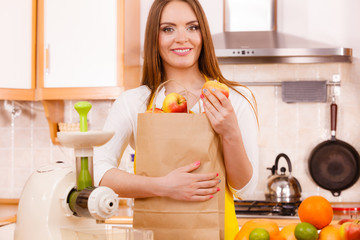 Woman housewife in kitchen with many fruits