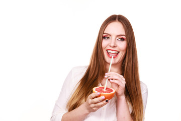 Woman holds grapefruit drinking juice from fruit