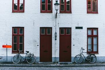 Fototapeta na wymiar Bicycle is very common and popular transport in Europe. Bicycles in european town street. Bruges, Belgium
