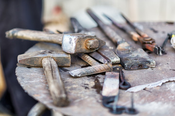 Blacksmith working on metal on anvil at forge high speed detail shot