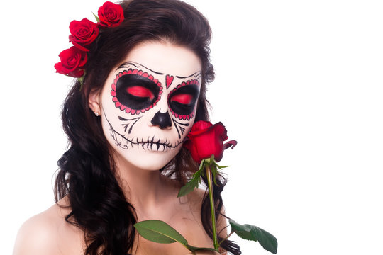 Day of the dead. Halloween. Young woman in day of the dead mask skull face art and rose. Isolated on white. closeup.