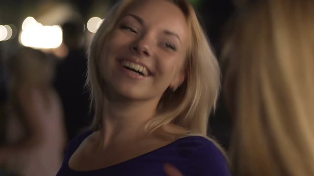 Beautiful homosexual women exchanging seductive looks at bar, flirting at party