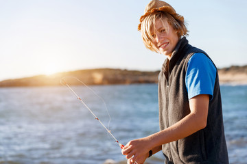 Teenage boy fishing at sea