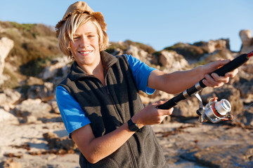 Teenage boy fishing at sea