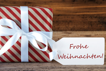 Fototapeta na wymiar Present With Label, Frohe Weihnachten Means Merry Christmas