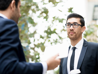 Two businessmen talking outdoors