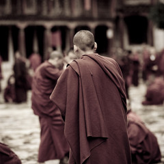 Monks in courtyard Kharchung Goemba,  Bumthang District