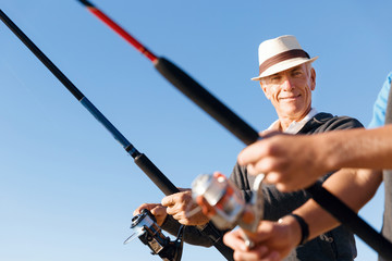 Senior man fishing at sea side