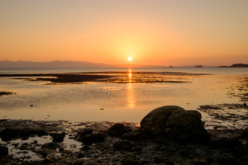 Fototapeta na wymiar ebb tide and sunset at Bakunyai island, Satun province , Thailan