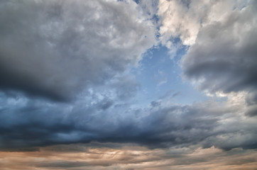 Naklejka na ściany i meble Background of clouds before a thunder-storm