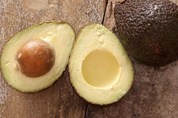 Halved healthy ripe tropical avocado pear