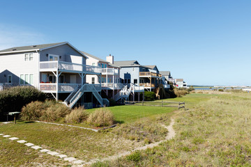 Luxury vacation beach rental houses along the green sand dunes; Sunset Beach, North Carolina