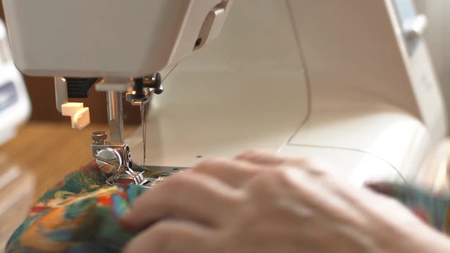 Closeup shot of woman's hand sewing on the sewing machine