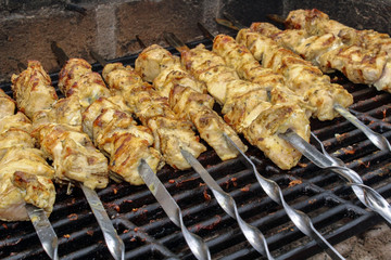 Shashlik on skewers closeup, raw and cooked
