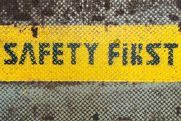 safety first sign on caution strip with text space at bottom
