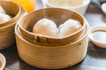 chinese steamed dimsum in bamboo containers  with soy sauce trad