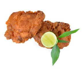 Fried chicken with lemon isolated on white.