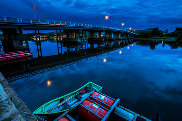 Fototapeta na wymiar Fishing Boat on calm water of river Over the night