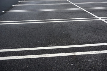 new paved empty parking lot with new painted strip lines