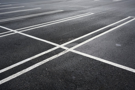 new paved empty parking lot with new painted strip lines