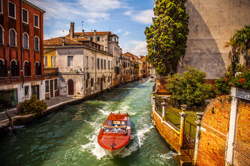 VENICE, ITALY - AUGUST 17, 2016: Retro brown taxi boat on water in Venice on August 17, 2016 in Venice, Italy. - 122204022
