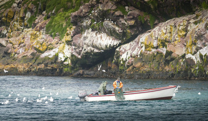 Small boat fisherman bring in crab pots
