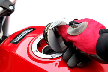 Men turn key motorcycle fuel tank.
