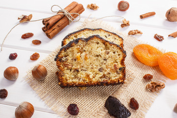 Fresh baked fruitcake with ingredients on boards