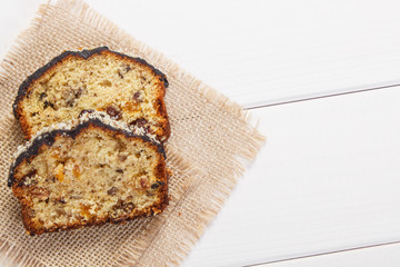 Fresh baked fruitcake on white boards, copy space for text