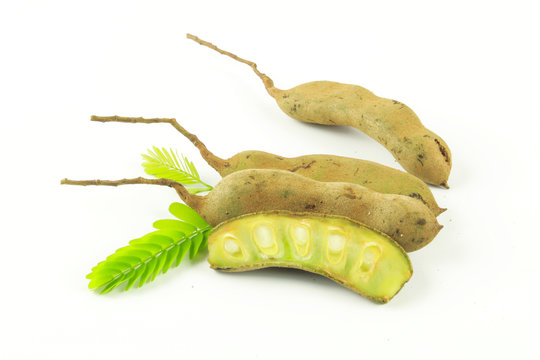 raw tamarind with leaf isolated on white background