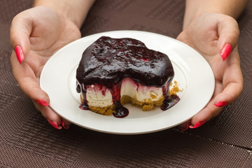 female hands hold slice cheesecake