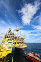 Fototapeta premium Offshore construction platform for production oil and gas, Oil and gas industry and hard work,Production platform and operation process by manual and auto function, oil and rig industry and operation.