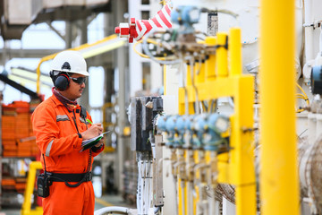 operator recording operation of oil and gas process at oil and rig plant, offshore oil and gas...