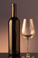 A glass and bottle of red wine