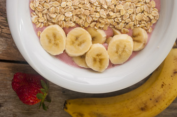 Healthy muesli breakfast with yoghurt, muesli, strawberries and banana