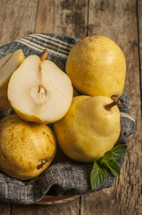 Naklejka na ściany i meble fresh ripe organic pears on a rustic wooden table