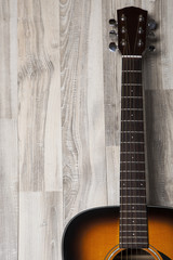 Fototapeta na wymiar Acoustic guitar on wooden background