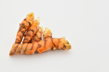 Abstract soft focus of turmeric tuber with the white copy space background.