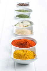 Various dried herbs and spices in bowl.