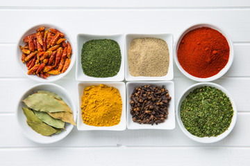 Various dried herbs and spices in bowl.