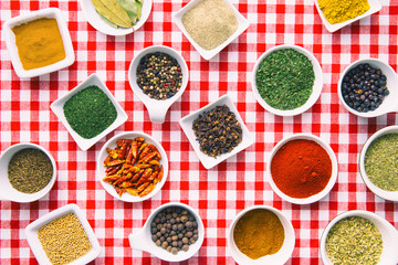 Various dried herbs and spices in bowl.