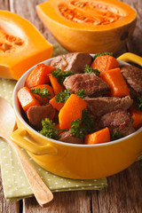 Healthy food: Beef stew with pumpkin and spices close up. Vertical
