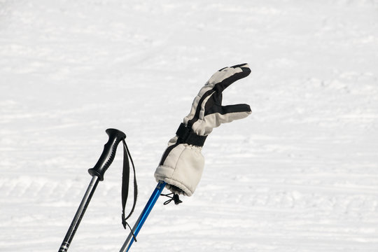 Skistöcke mit Handschuh im Schnee