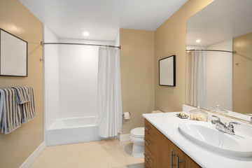 Naklejka na ściany i meble Bathroom interior in beige and wood cabinets and mirror and copy