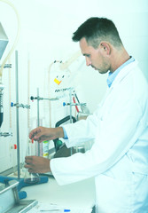 Adult man working on quality of products in lab