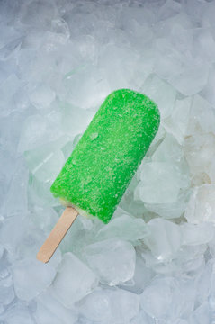 Ice-cream popsicle sticks lemon ice crystals on ice cubes..
