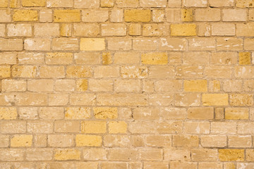 Yellow and brown brick wall, background, texture