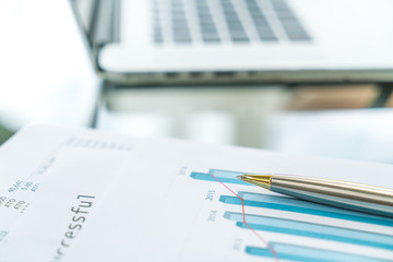 Financial charts on the table with laptop .