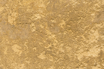 Yellow stone surface with a crack